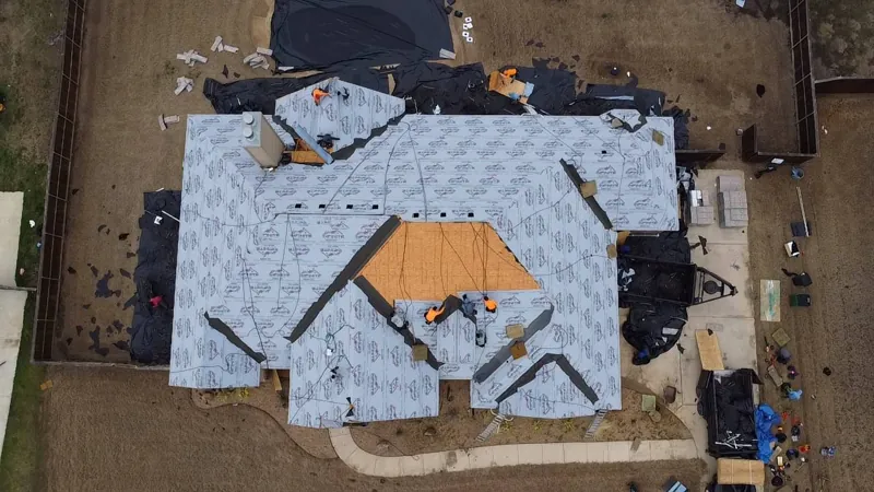 roof replacement in progress with underlayment installed